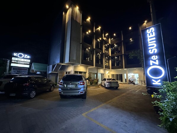 A hotel entrance with a modern design, featuring a prominent sign for KOZE SUITES. - Koze Suites (Dumaguete)