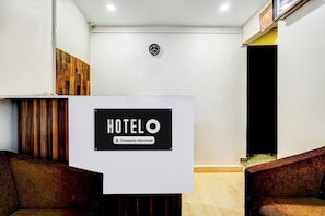 A reception desk with a sign that reads 'HOTELO Company-Serviced'.