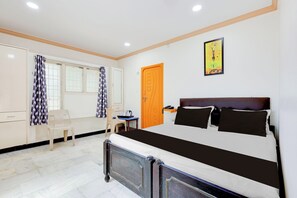 A bedroom with a bed, a desk, a chair, and a door. - Super Hotel O Guntur Railway Junction (Guntur)