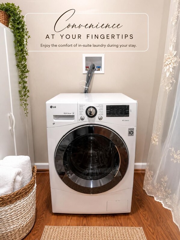 A compact, modern laundry machine in a clean, well-lit room with a wicker basket and a white towel on the floor.
