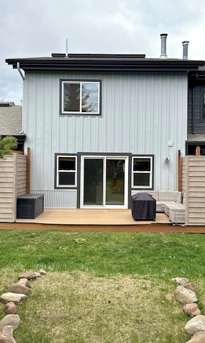 A modern two-story house with a deck, large windows, and a chimney. - SlopeTown Retreat - Big Sky Meadow (Big Sky)