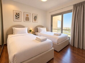 A hotel room with two beds, a large window, and three wall-mounted artworks. - Vesta - Luxury Apt- 3br - cfc Xlvii (New Cairo)