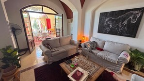 A living room with two sofas, a coffee table, and a painting on the wall. - Vesta - Luxury Twin House - 3BR - Nubia (El Gouna)