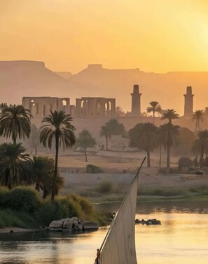 A desert landscape with palm trees and ancient ruins in the background. - Vesta - Luxury APT - 2BR - Water Side (El Gouna)