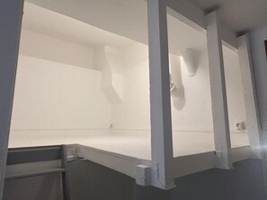 A room with a large, empty space, possibly a pool or water feature, with a dark floor and white walls. - Loft Folie r nov Proche R Publique Marais (Paris)