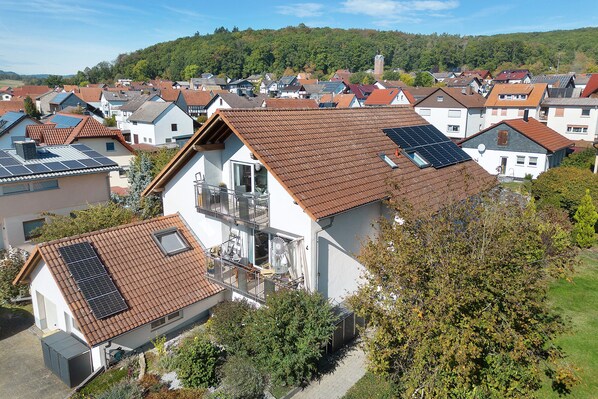 A residential area with houses featuring sloped roofs and solar panels.