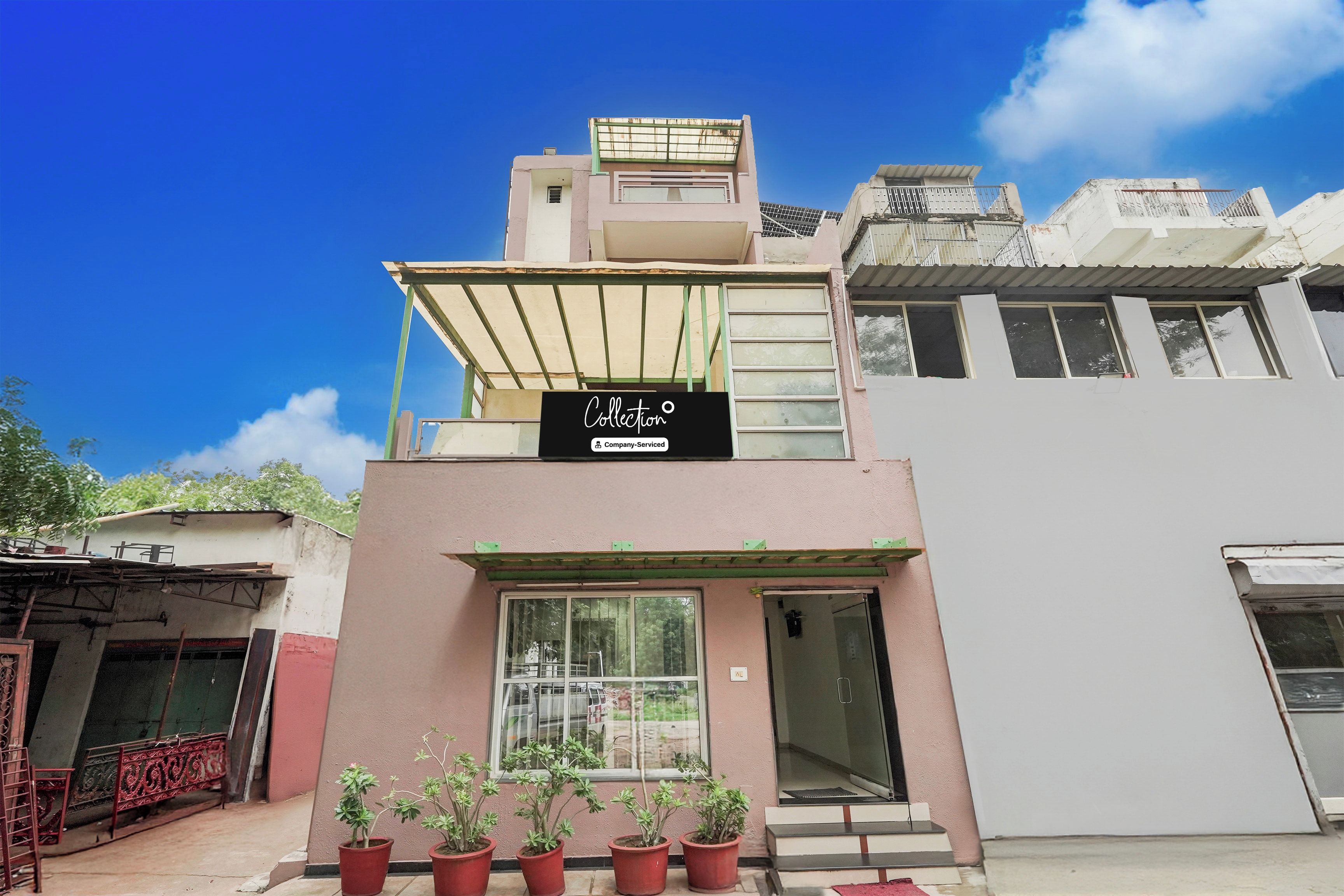 A building with a sign indicating it is a company-serviced collection.