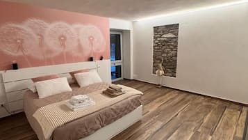 Un dormitorio con cama, pared de piedra y un mural de diente de león.