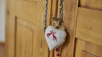 A wooden door with a heart-shaped ornament featuring reindeer silhouettes.