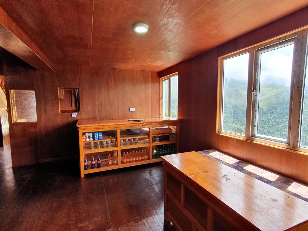 A wooden interior with a long table and a shelf unit.