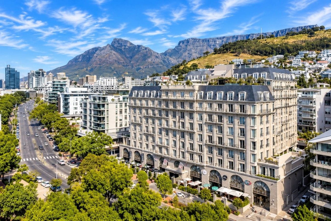 A cityscape with a prominent building featuring multiple floors and a central courtyard.