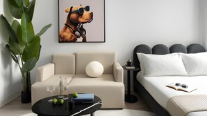A modern bedroom with a sofa, a bed, a coffee table, and a large plant. - Miles at Ybor - Tampa (Tampa)