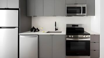 A modern kitchen with a built-in microwave, oven, and dishwasher.