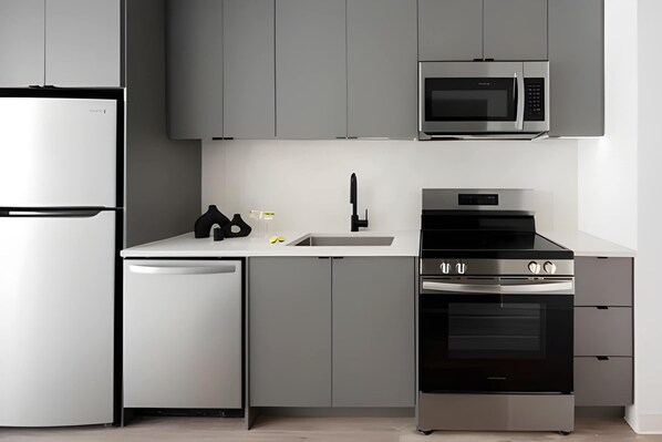 A modern kitchen with a built-in microwave, oven, and dishwasher.
