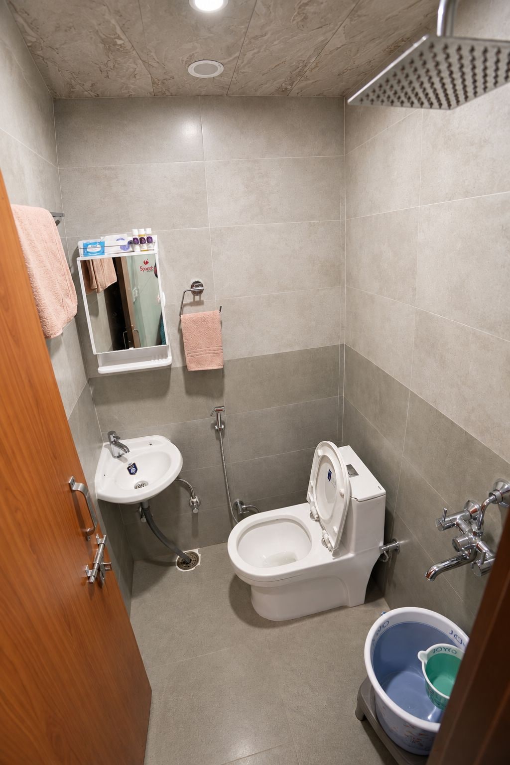 A bathroom with a toilet, sink, and shower.