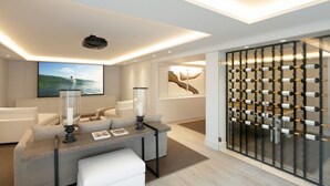 A modern living room with a sofa, a coffee table, and a wine rack. - Vrbo Property (Marbella)