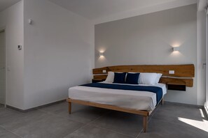 A modern bedroom with a wooden bed frame, white bedding, and two wall-mounted lights. - Sky Star Luxury Guest House Luna Queen Deluxe (Foligno)
