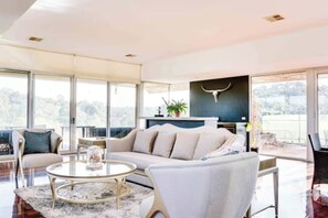 A modern living room with a sofa, coffee table, and a large window. - Grand Leisure Estate in Yarra Valley (Wonga Park)