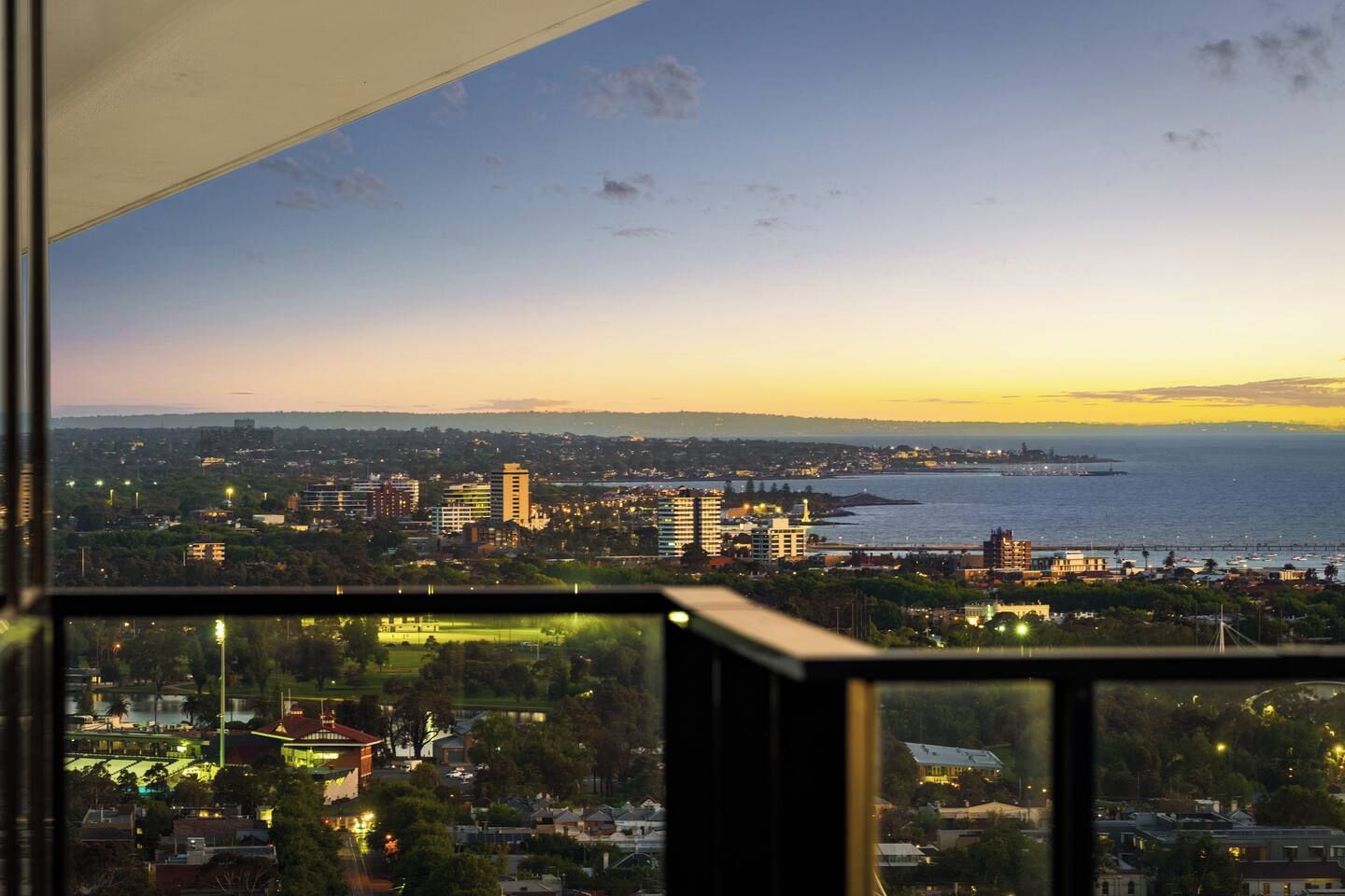 A cityscape with buildings, a body of water, and a clear sky.