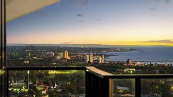 A cityscape with buildings, a body of water, and a clear sky.