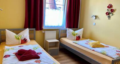 Bright twin room with a private bathroom—within walking distance of downtown and Wartburg Castle