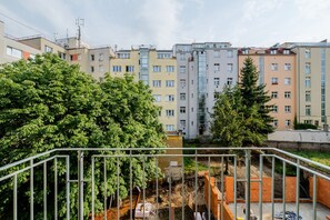A residential building with multiple floors, balconies, and a construction site in the foreground. - Nusle Residence by Blueground (Prague)
