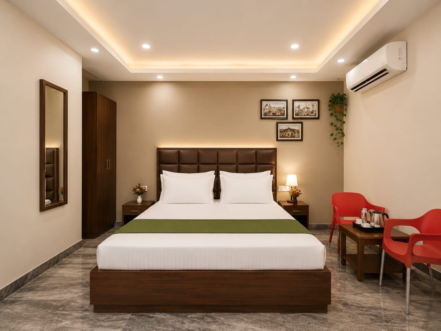 Una habitación de hotel con una cama grande, mesitas de noche, un escritorio con sillas y un equipo de aire acondicionado.