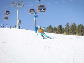 A ski slope with a chairlift and skiers. - One-bedroom Cabin (Sankt Georgen am Kreischberg)