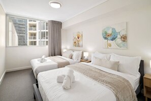 A hotel room with two beds, a large window, and artwork on the walls. - Suite 1108 : Spacious CBD 3 Beds +Pool, Gym & Parking (Brisbane City)