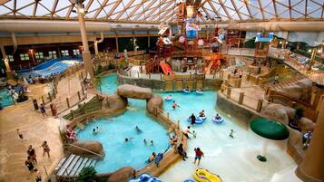 An indoor water park with multiple pools, slides, and play areas.