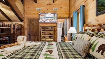 A cozy cabin interior with a bed, a wooden door, and a view through a window.