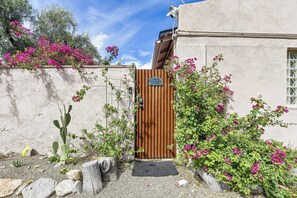 A rustic gate with a wooden door, a metal gate, and a small wooden post. - Great Walkable Location! Tucson Studio Stay (Tucson)