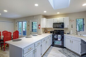 A kitchen with white cabinets, a black microwave, and a red fire extinguisher. - 2 Mi to Beech Mtn Resort Lifts: Family Home (Banner Elk)