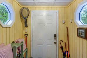 A room with a white door, a tennis racket, a broom, and a picture frame on the wall. - 2 Mi to Beech Mtn Resort Lifts: Family Home (Banner Elk)