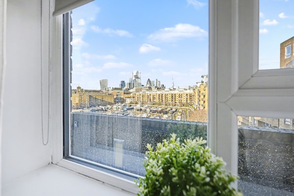 A view from a window overlooking a cityscape with buildings and a marina. - Cosy Tower Bridge | Waterside | St Katharine Docks (Greater London)