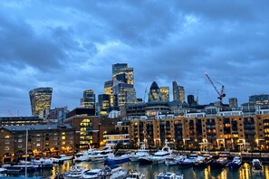 A city skyline with modern buildings and a marina with boats. - Cosy Tower Bridge | Waterside | St Katharine Docks (Greater London)
