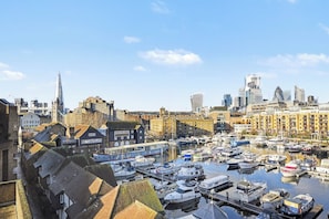 A marina with boats docked, surrounded by historic buildings and modern skyscrapers. - Cosy Tower Bridge | Waterside | St Katharine Docks (Greater London)