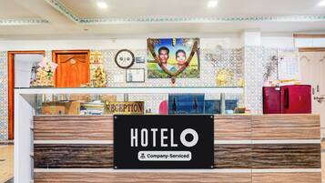 Una recepción con un letrero que dice 'HOTEL', un reloj y un calendario.