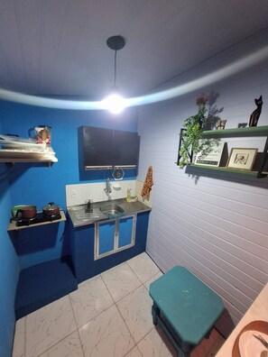 A compact kitchen with a sink, stove, and a small countertop.