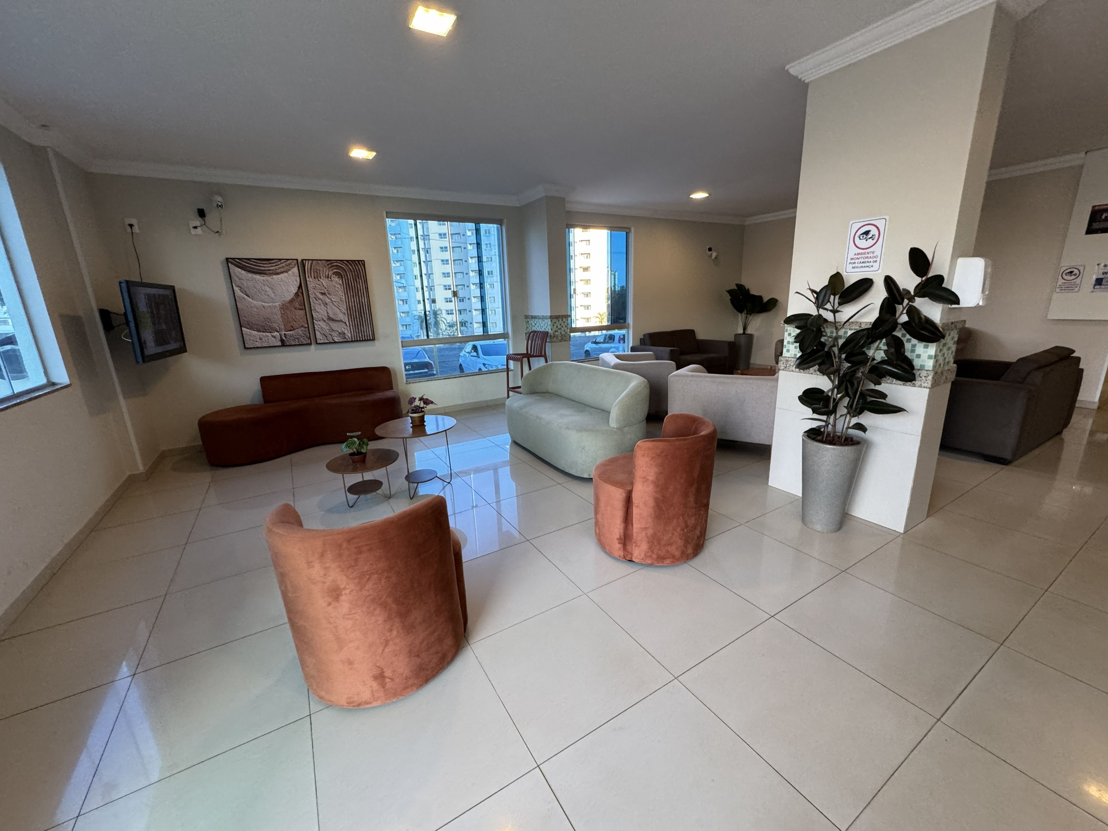 A spacious living area with a sofa, armchairs, and a coffee table.