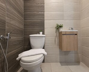 Une salle de bain moderne équipée de toilettes, d’une douche et d’un lavabo.