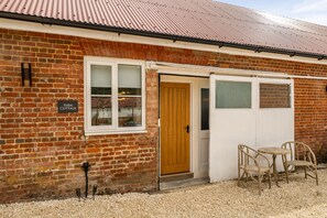 A brick building with a wooden door, a window, and a sign that reads 'Fern Cottage.' - Fern Cottage, Hamptworth, Hampshire (Salisbury)