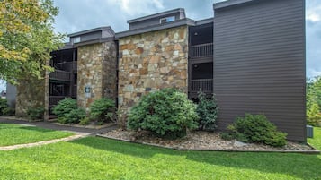 A modern building with a stone facade and a dark wooden exterior.