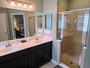 A bathroom with two sinks, a shower, and a large mirror. - Modern Open Concept 3/2 Retreat (Orange Park)