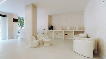 A modern, minimalist lounge area with seating arrangements and a coffee machine.