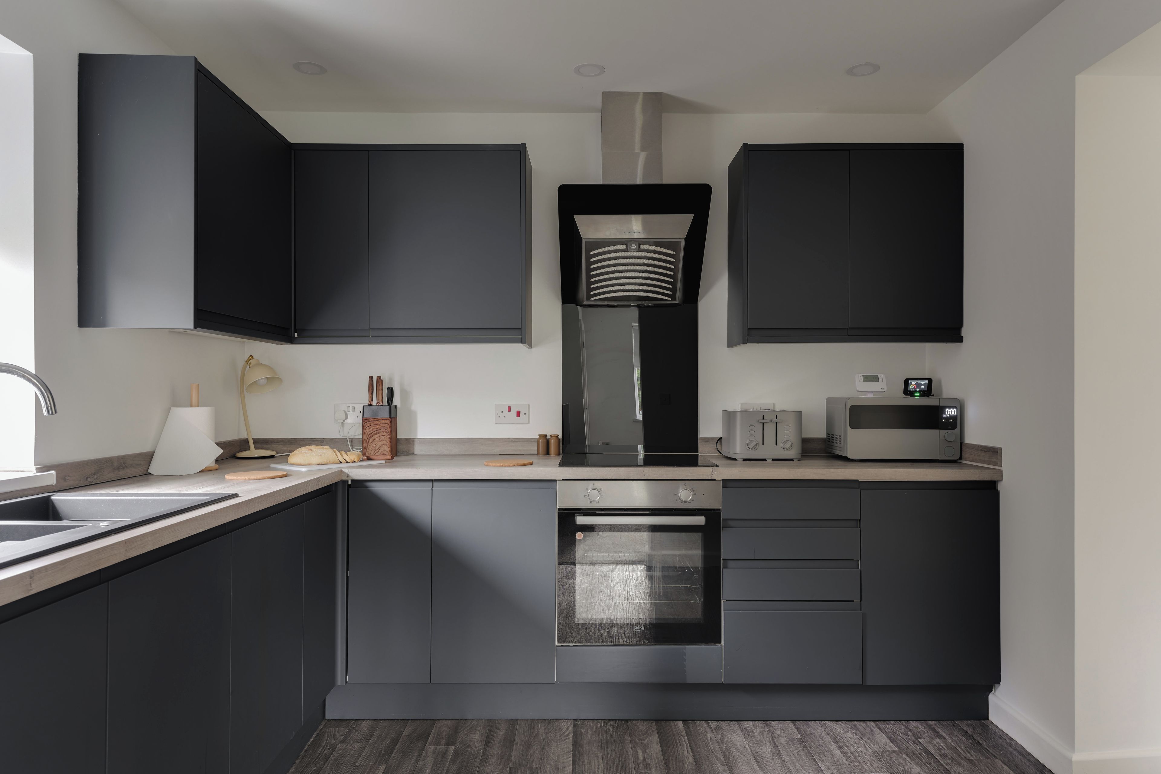 Stylish modern kitchen with sleek dark cabinets and generous workspace