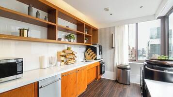 A modern kitchen with wooden cabinets, a microwave, and a sink.