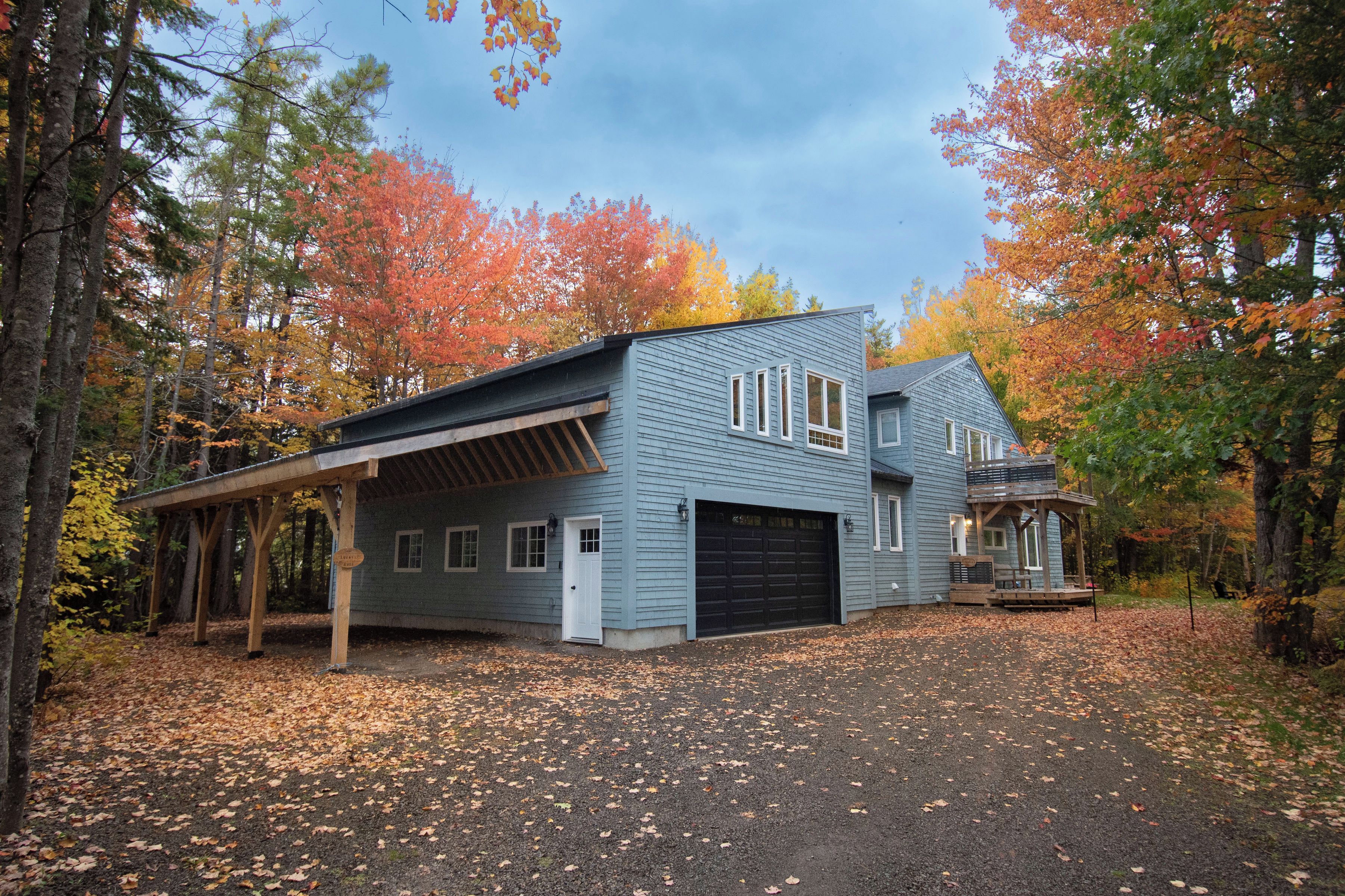 A two-story house with a covered porch and a garage.
