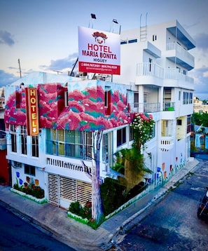 A hotel with a colorful facade, a prominent sign, and a balcony. - Room-hotel Maria Bonita H6 (Higuey)