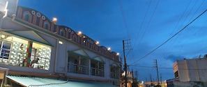 A building with a distinctive architectural style, featuring a prominent overhang and multiple windows. - SINGHBHUM-The Shore (Kanthi)
